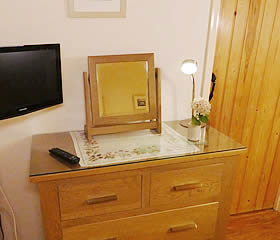 Menabilly - TV and chest of drawers