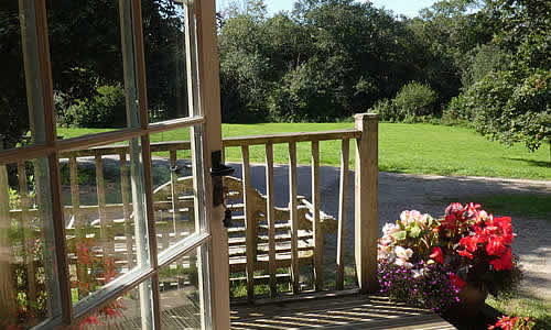 Views from the apartments over the lawned garden and woodland